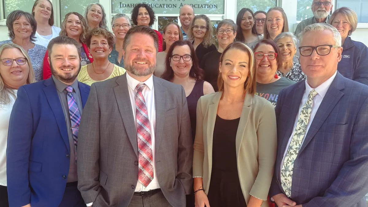 A group of people smiles at the camera
