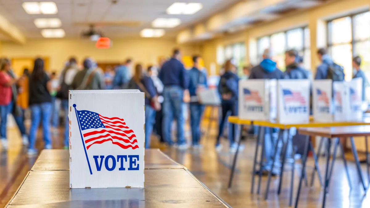 photo of polling location with a vote sign featuring an U.S. flag