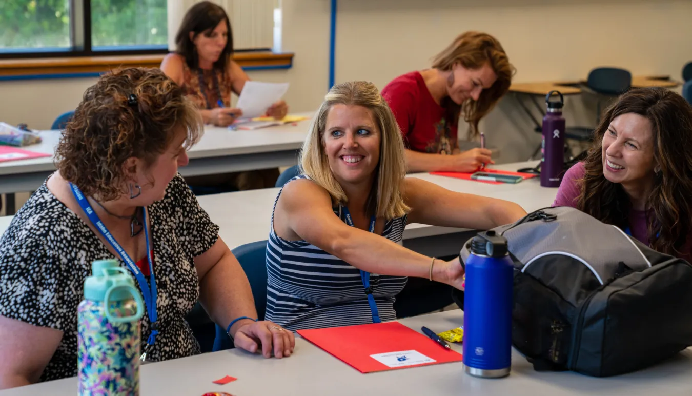 Women educators talking in classroom