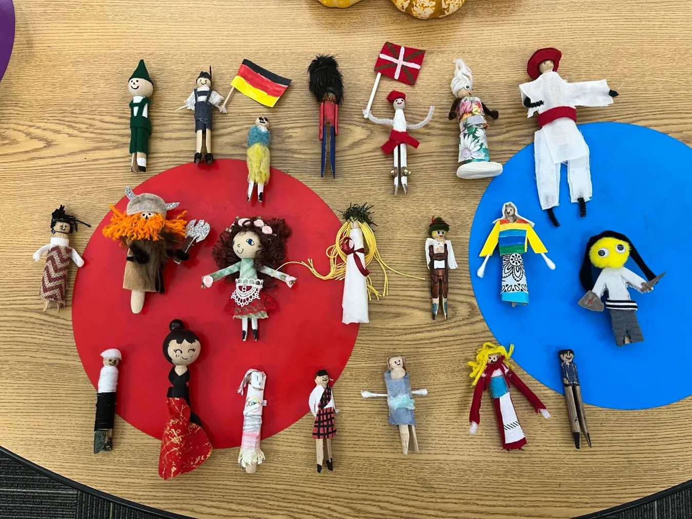 Rows of colorfully dressed clothespins decorated to look like people