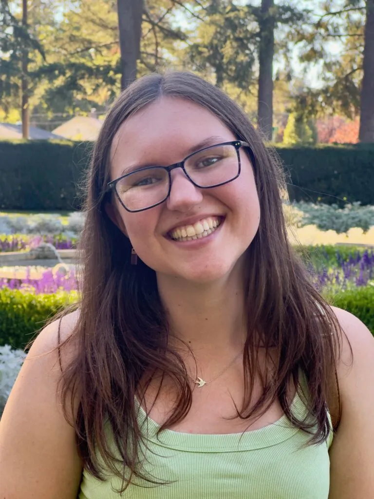 A brown haired woman smiles at the camera