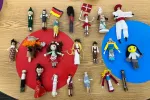 Rows of colorfully dressed clothespins decorated to look like people