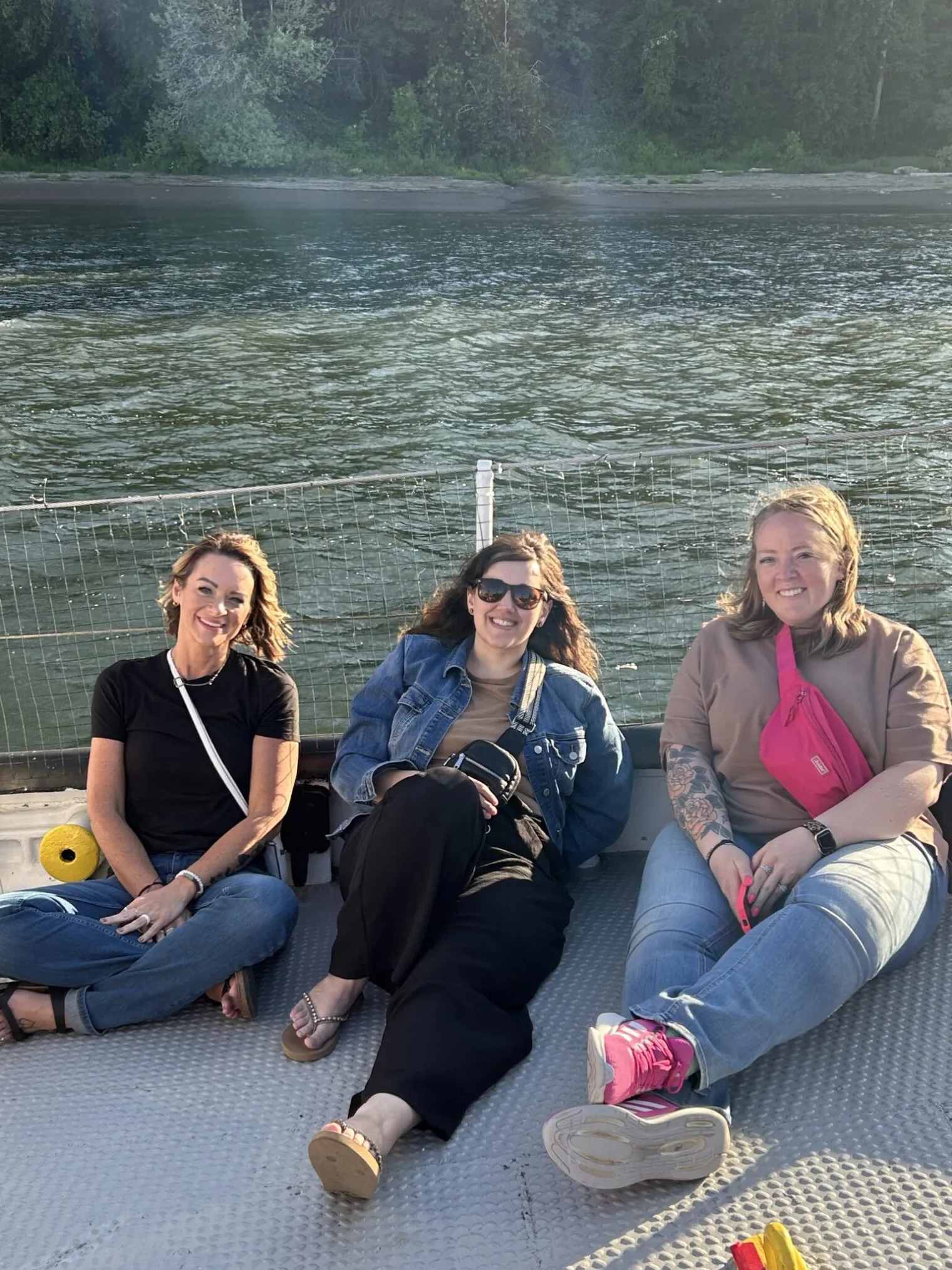 Three women relax on the deck of a boat