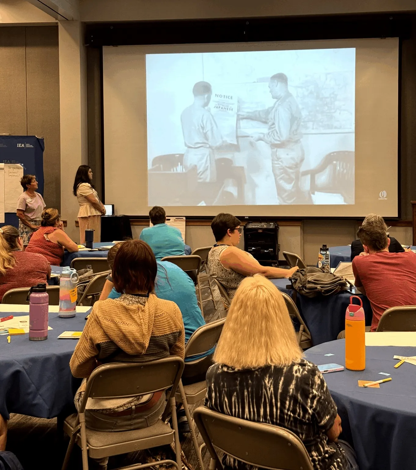 A group of educators watches a presentation about the Minidoka Concentration Camp. 