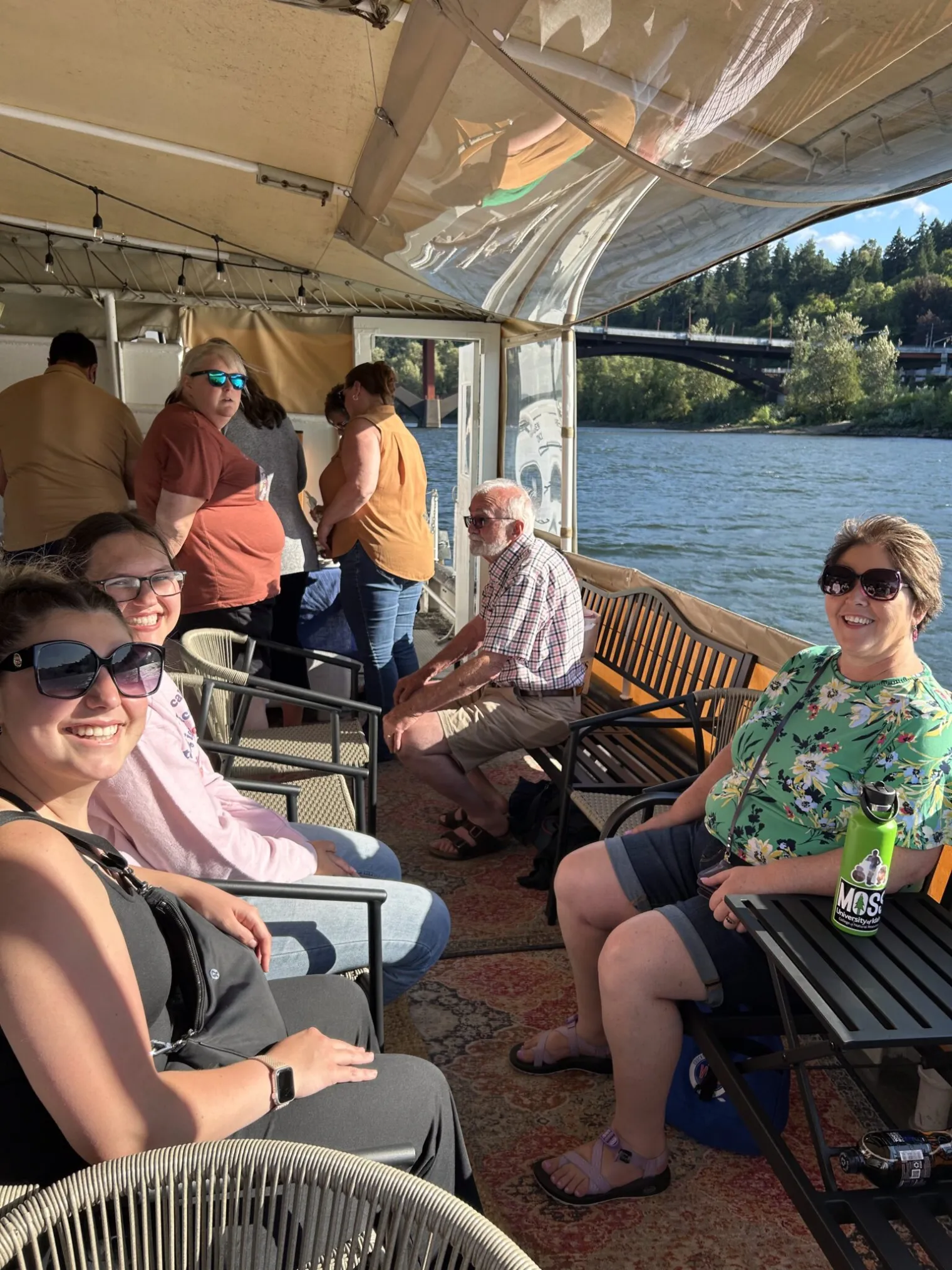 Women smile from the deck of a boat