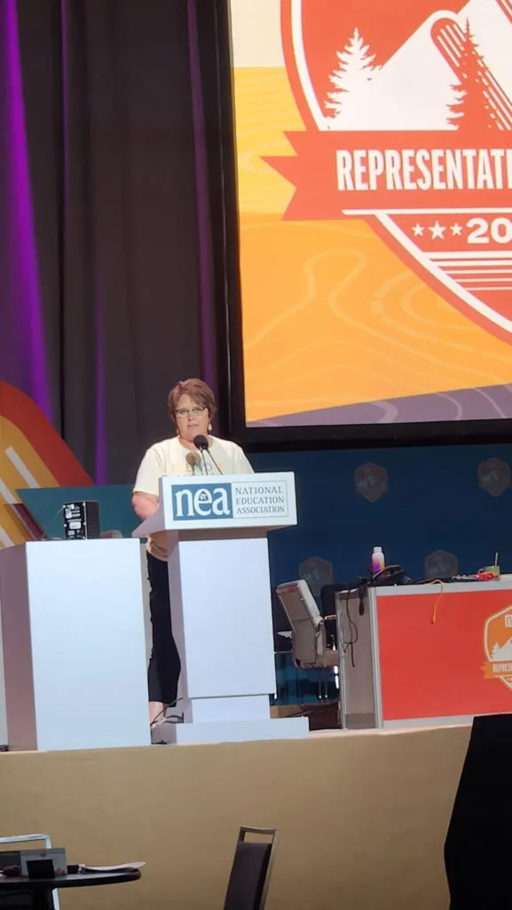 A woman speaks from a podium