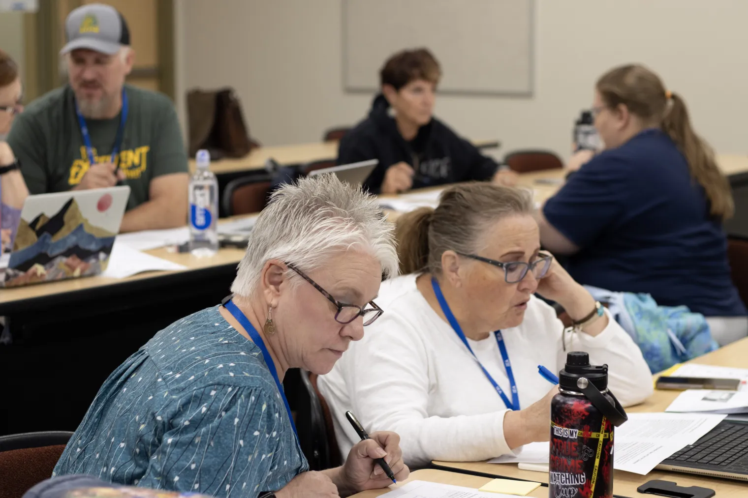 People in a classroom focus on their work
