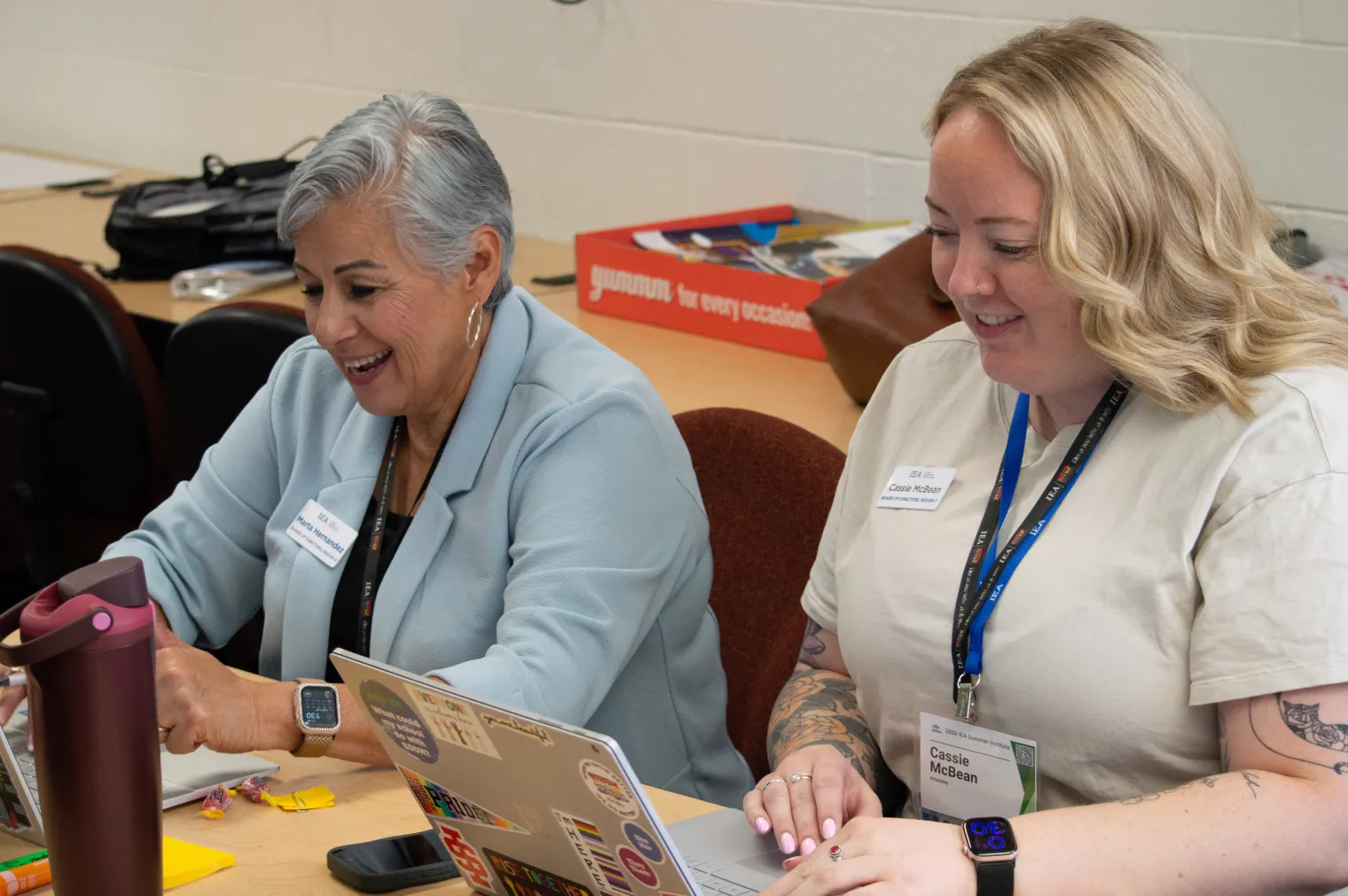 Two women work on computers