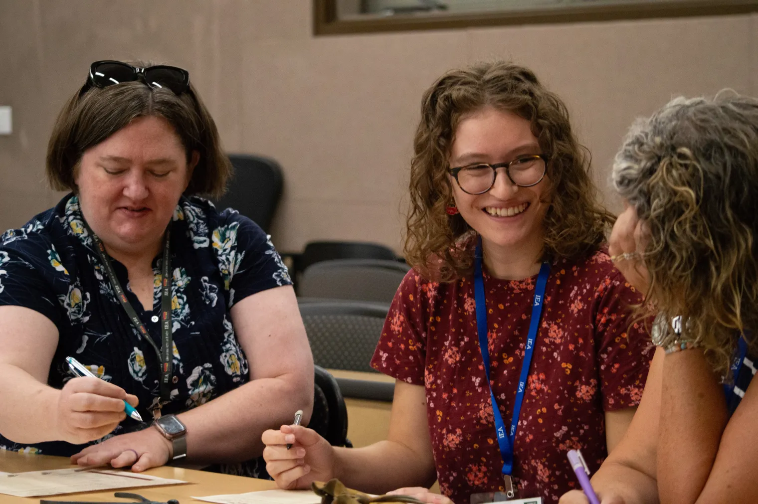 Three women work on a project together