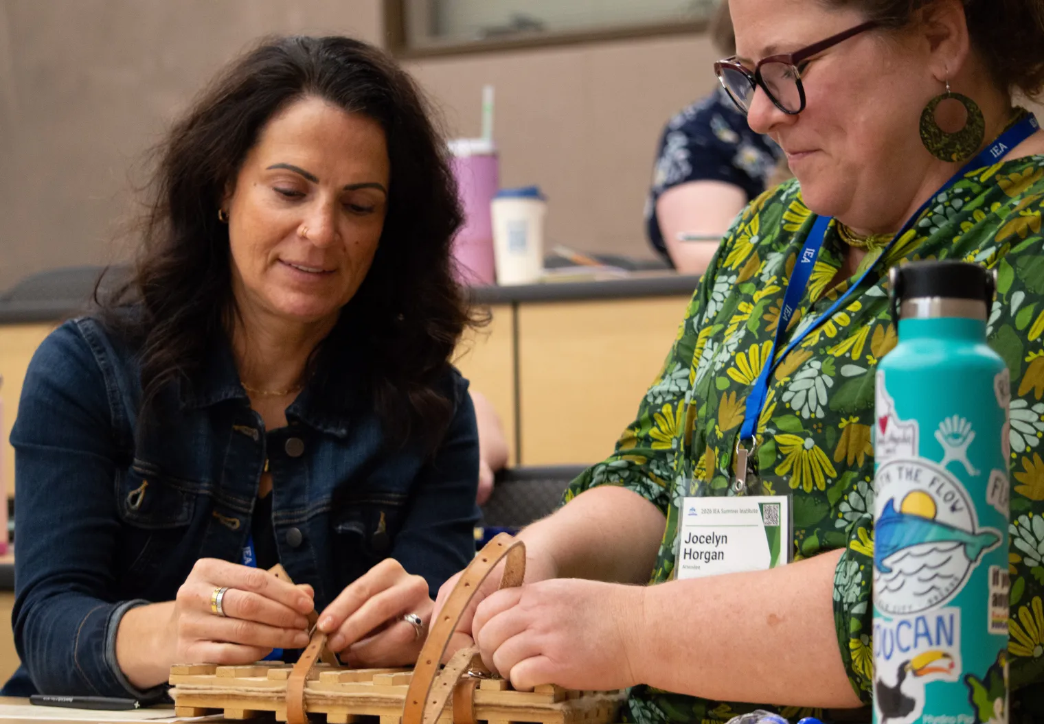 Two women secure an old-fashioned plant press