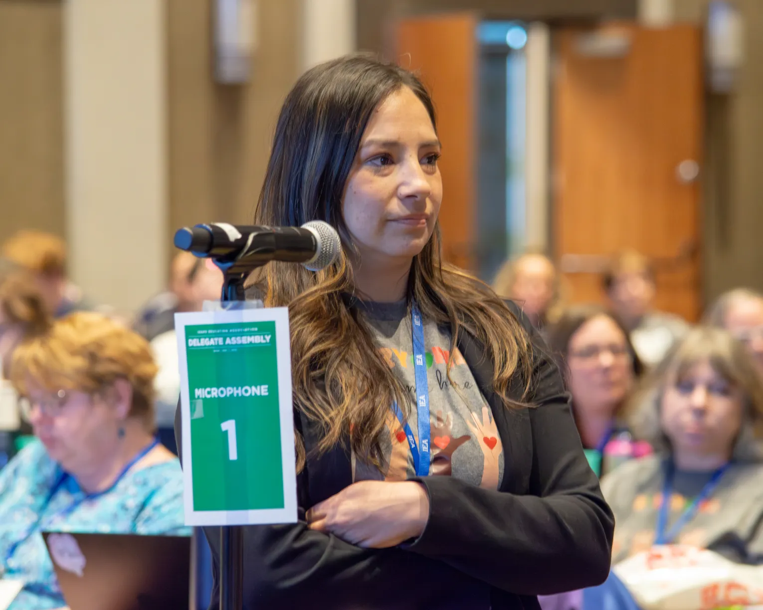Member stands at a microphone. 