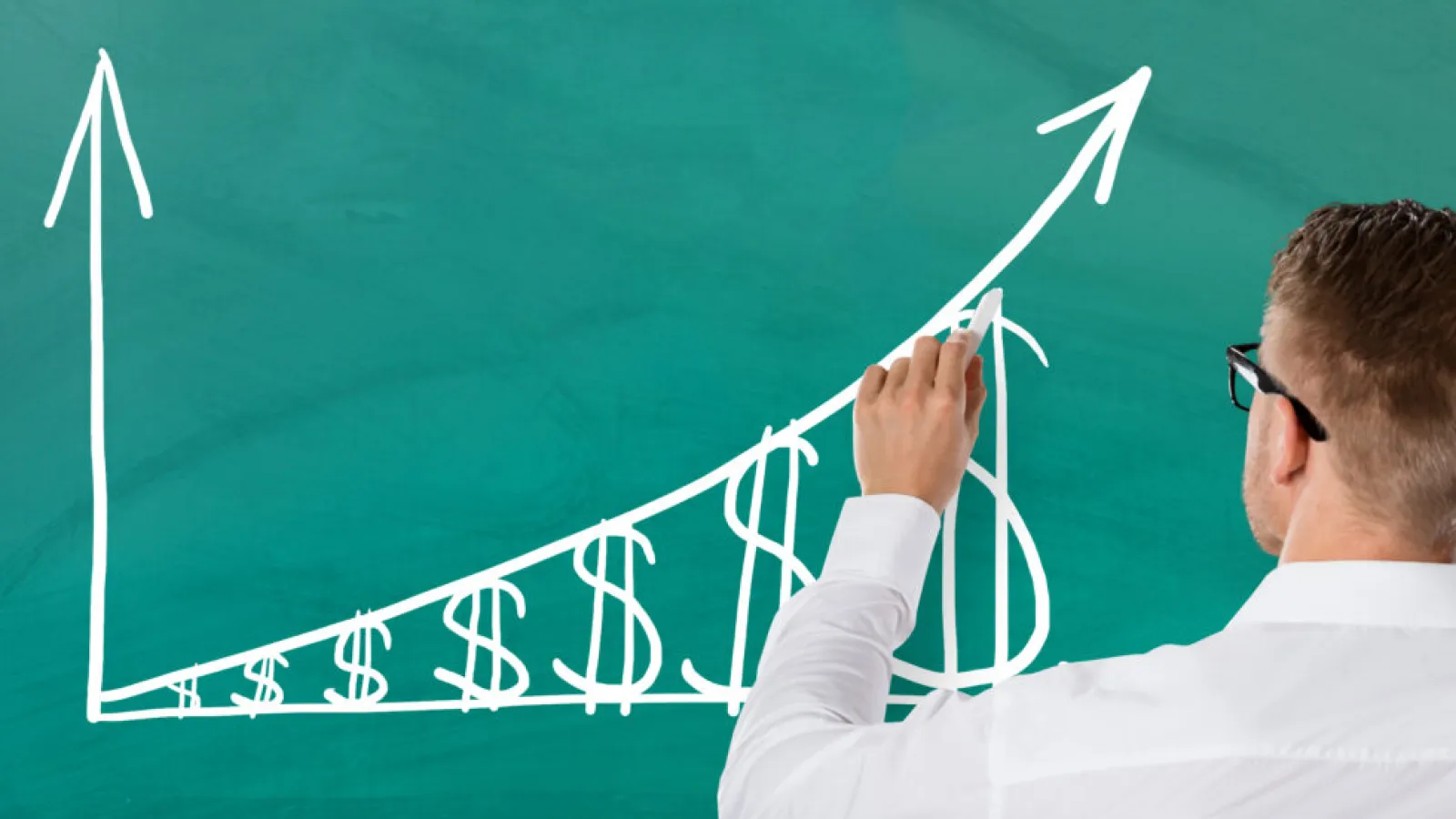 A photo of a man drawing a graph on a chalkboard