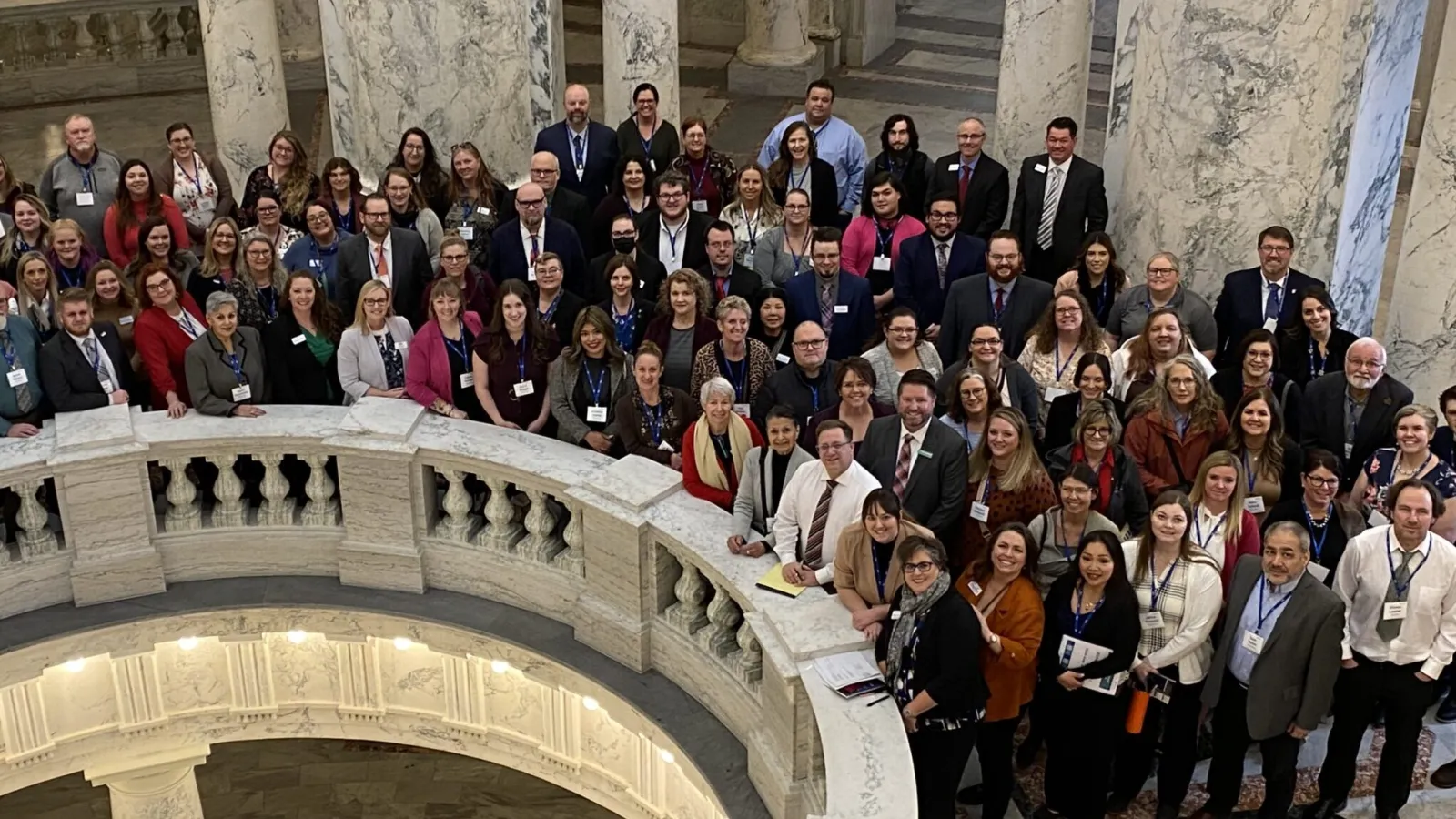 A large group of people assembled around the second floor of the Idaho Statehouse rotunda