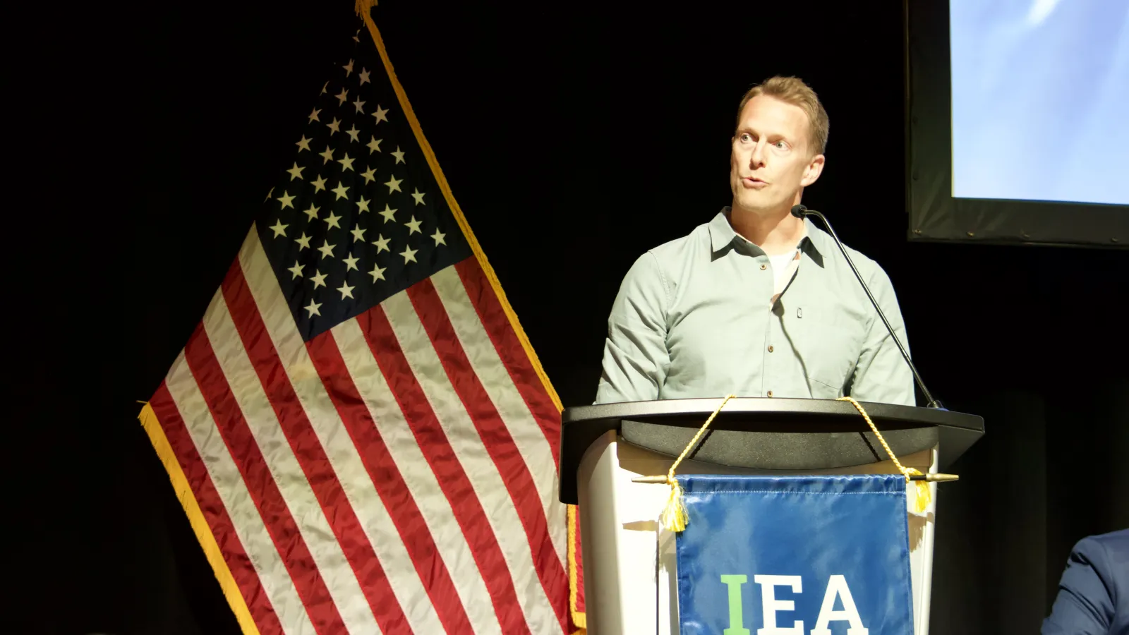 A man speaks behind a podium