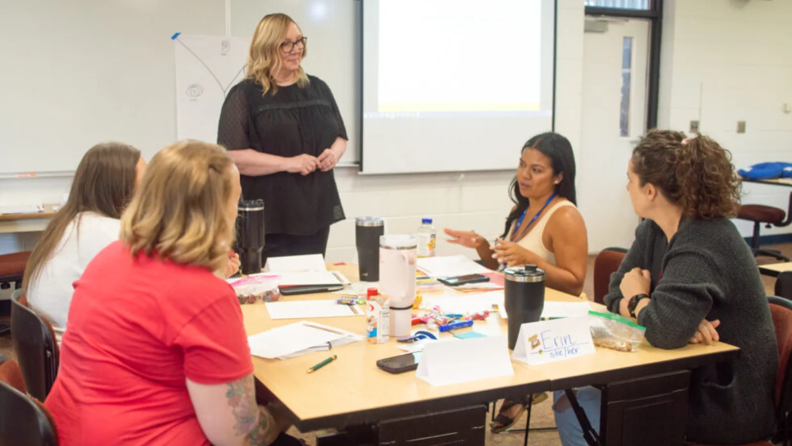 A group of women listens to one of them speaking