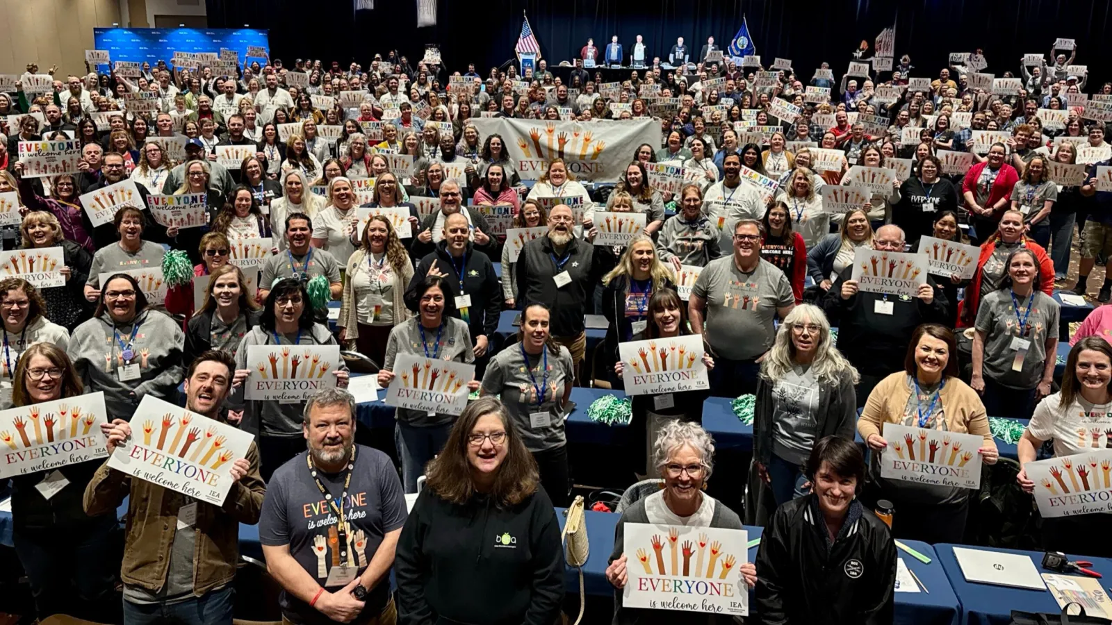 group phote everyone is welcome here signs IEA DA