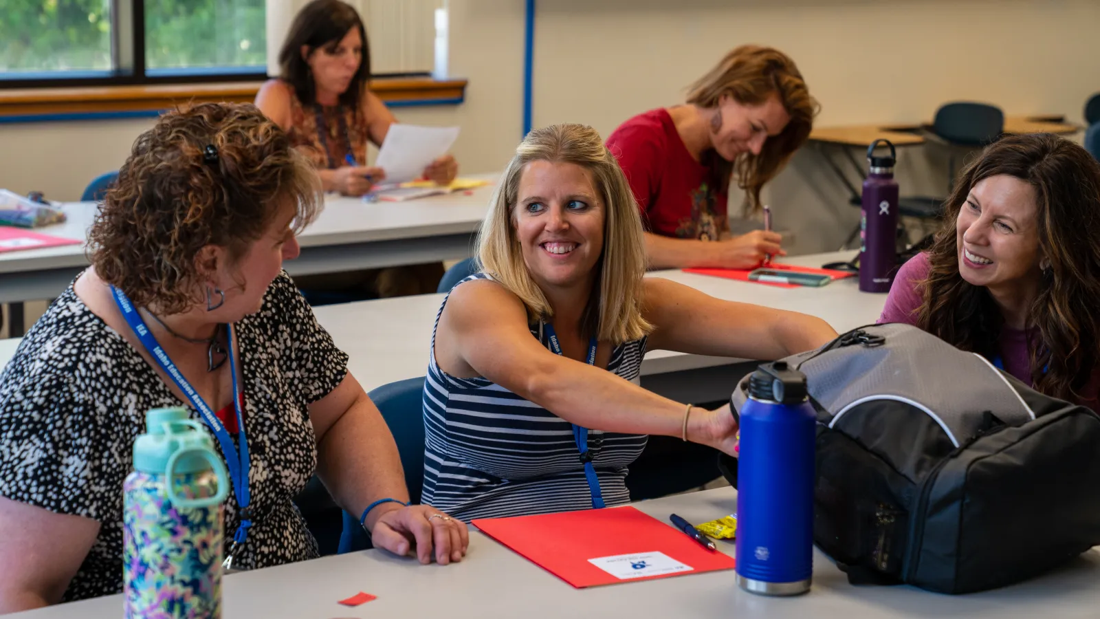 educators chatting at conference in a classroom