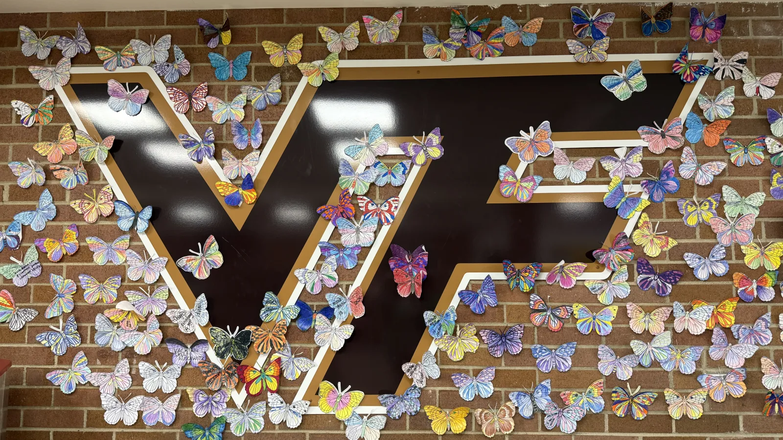 A picture of the Vallivue logo surrounded by paper butterflies