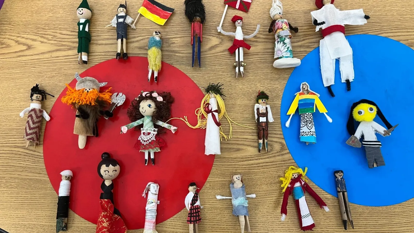 Rows of colorfully dressed clothespins decorated to look like people