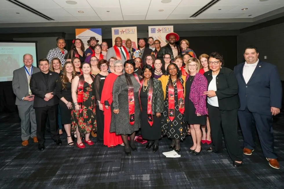 A group of well-dressed people smiling for the camera