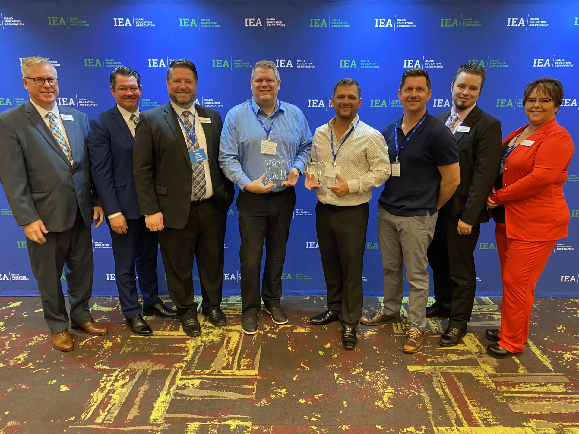 A group of people pose for a photo with awards