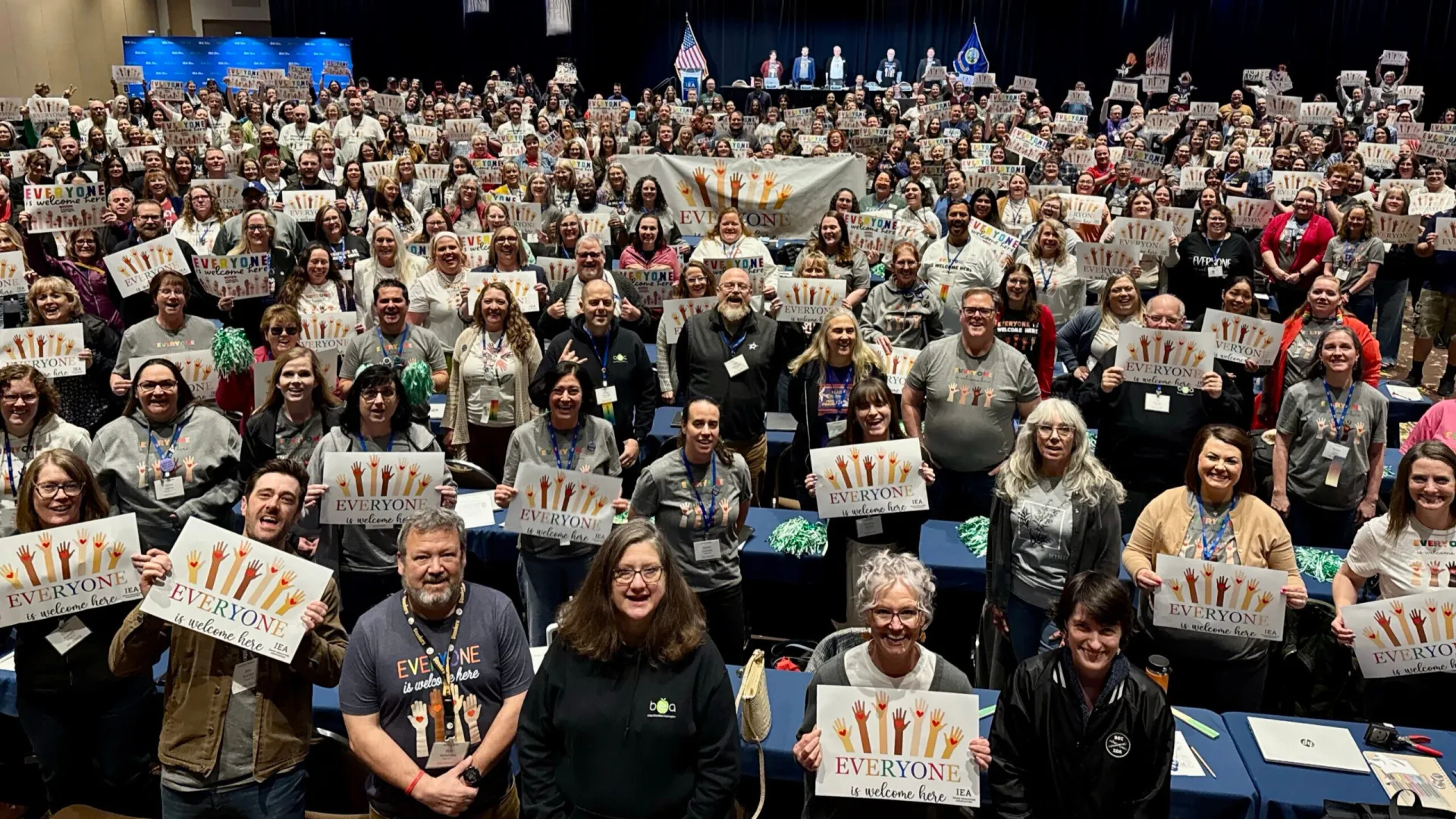 group phote everyone is welcome here signs IEA DA