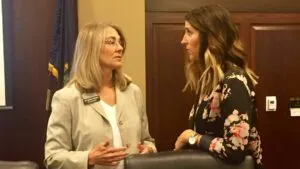 Two women appear deep in conversation in the Idaho Statehouse