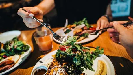 A shot of two people eating at a restaurant