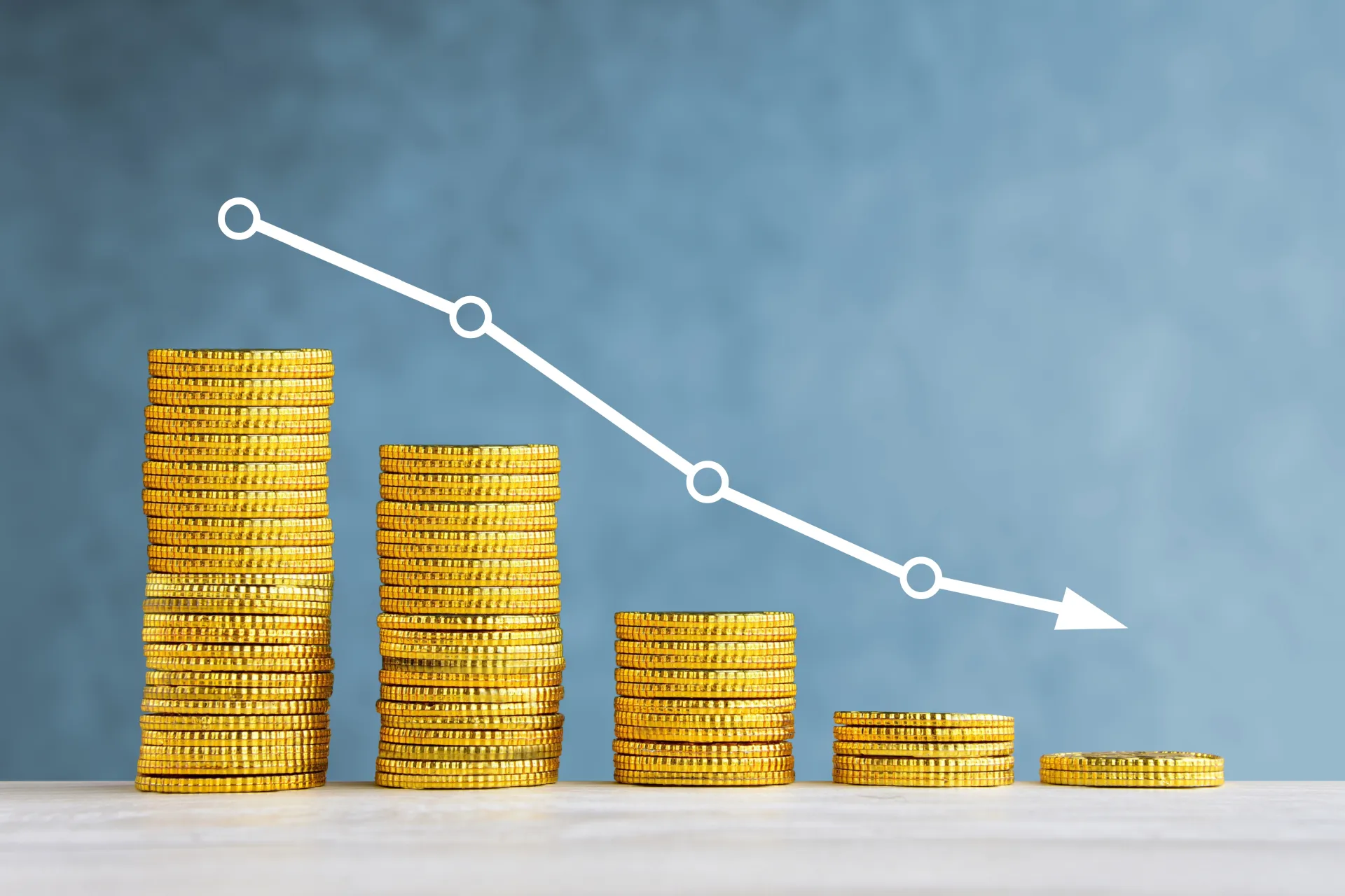 A photo illustration of decreasing stacks of coins