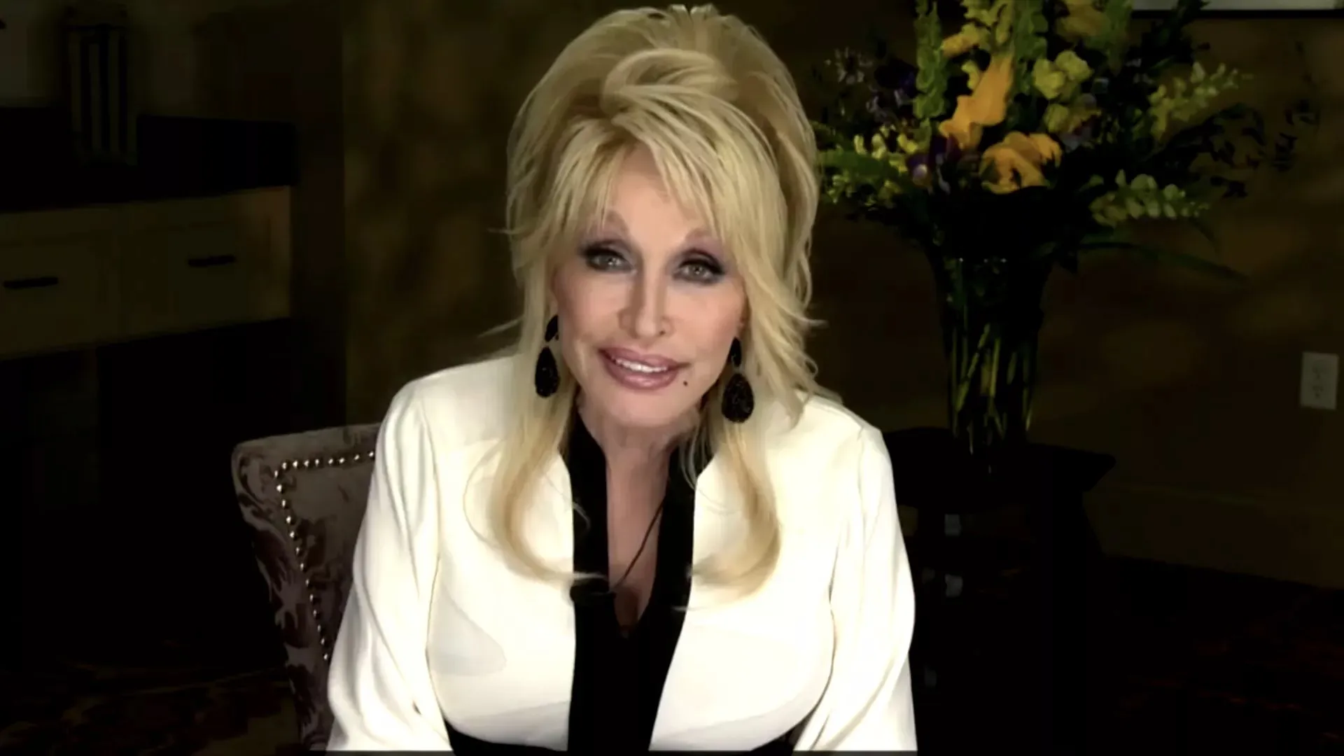 An image of Dolly Parton in a white-and-black shirt