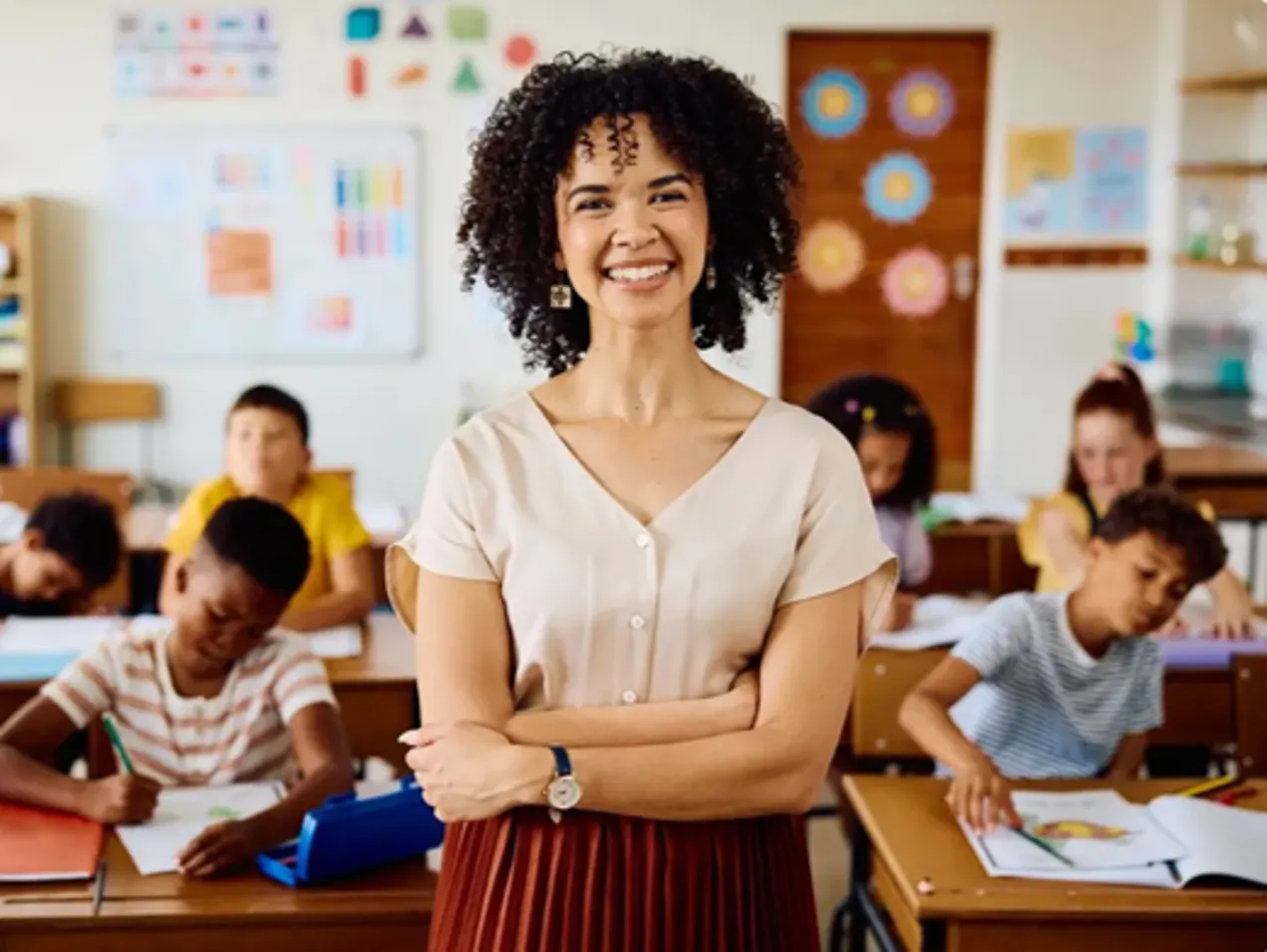 smiling teach in front of class looking out