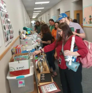 A group of educators looks through items on a table