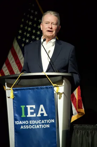 Governor Brad Little speaks at a podium