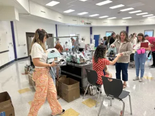 Educators deliver goodie bags to their colleagues