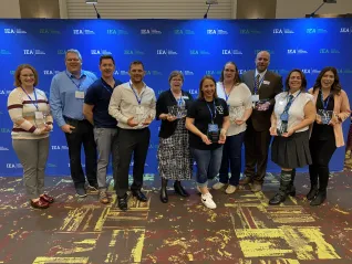 A group of people hold awards