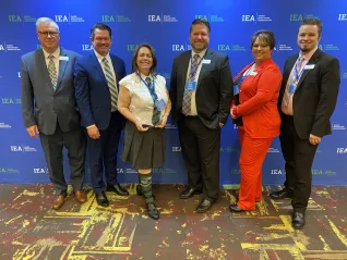 A woman wearing a Harry Potter costume accepts an award