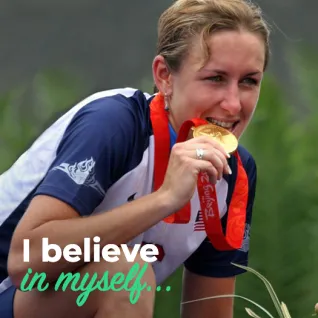 Olympian Kristen Armstrong is pictured biting her gold medal. 