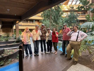 A group of people hold phones to their ears