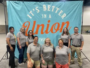 A group of people in front of a union background