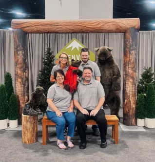 Two men and one women posed with stuffed bears