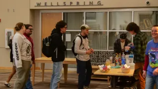 A man makes non-alcoholic drinks for people waiting in line
