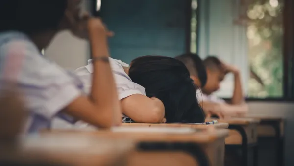 Student lays head down on desk. 
