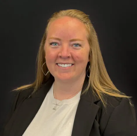 A woman with long hair wearing a black blazer