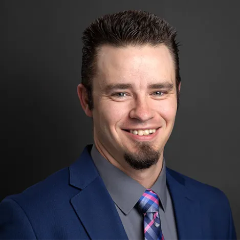 A man with dark hair and a goatee