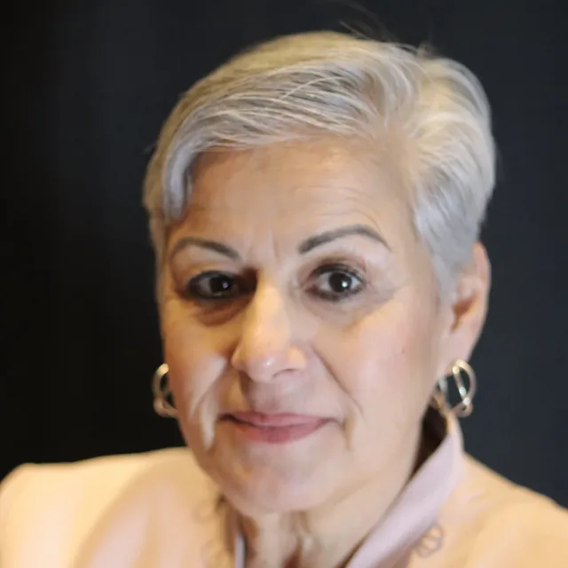 A woman with short white hair 