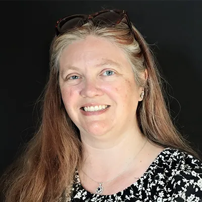 A woman with long hair and a black-and-white top