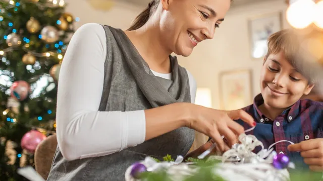 Adult and child wrapping a present