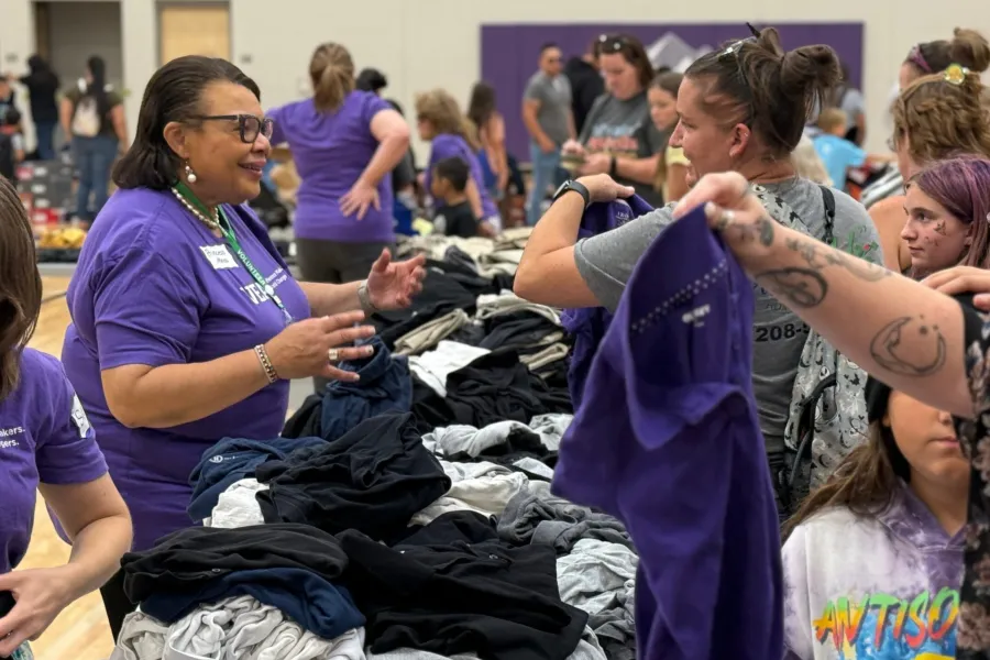 Princess Moss, vice president of NEA, pitches in at the VEA's annual Back to School Fair last Saturday.